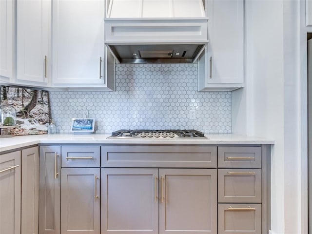 1218 NW 21st St, Oklahoma City, OK 73106 - kitchen with stainless steel gas cooktop, decorative backsplash, custom range hood, and gray cabinetry