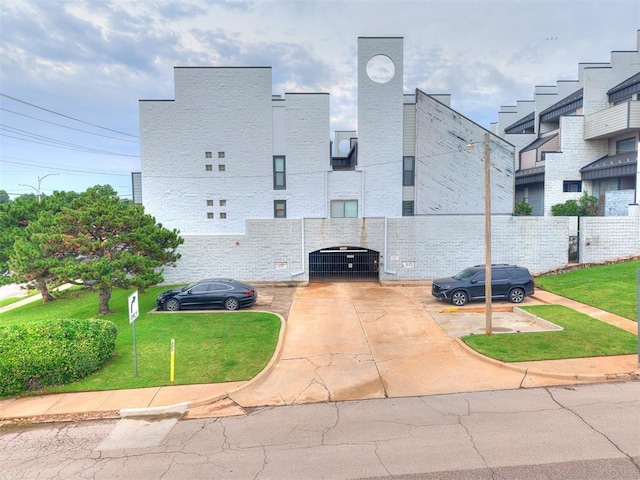 931 NW 7th St Unit 104, Oklahoma City, OK 73106 - view of property featuring uncovered parking