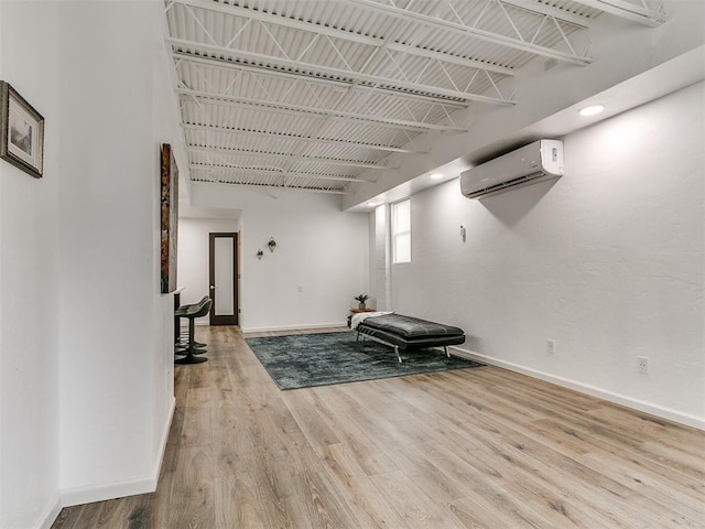 931 NW 7th St Unit 104, Oklahoma City, OK 73106 - unfurnished room featuring an AC wall unit and wood finished floors