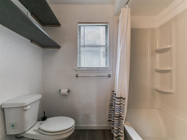 931 NW 7th St Unit 104, Oklahoma City, OK 73106 - bathroom featuring wood finished floors and shower / bath combo with shower curtain