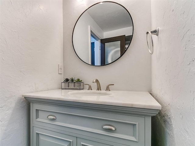 931 NW 7th St Unit 104, Oklahoma City, OK 73106 - bathroom with vanity and a textured wall