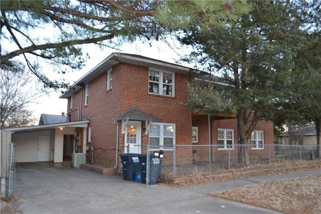 128 W Ridgewood St, Shawnee, OK 74801 - view of front of home featuring brick siding, a carport, and driveway