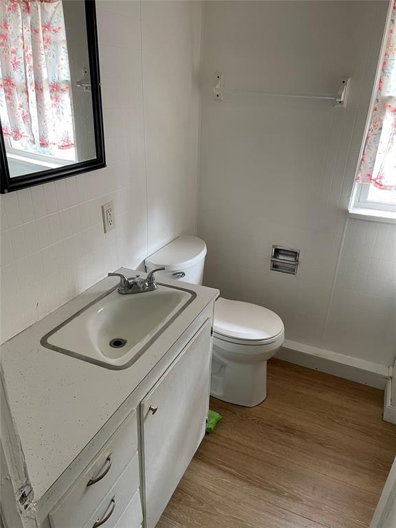 128 W Ridgewood St, Shawnee, OK 74801 - bathroom with vanity, toilet, and wood finished floors