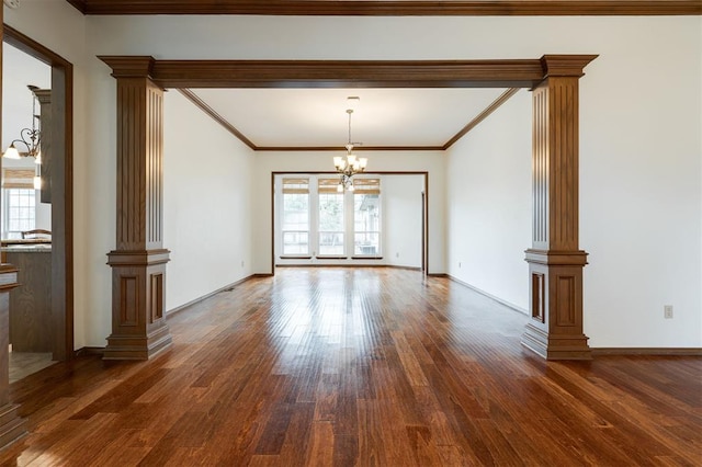 2613 NW 159th St, Edmond, OK 73013 - empty room with a chandelier, dark wood-style floors, healthy amount of natural light, decorative columns, and crown molding