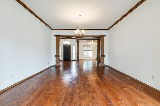 2613 NW 159th St, Edmond, OK 73013 - unfurnished room with a chandelier, decorative columns, wood finished floors, ornamental molding, and baseboards