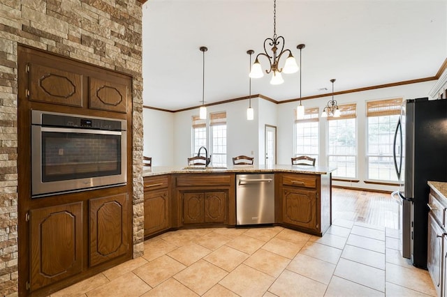 2613 NW 159th St, Edmond, OK 73013 - kitchen featuring stainless steel appliances, a sink, a chandelier, crown molding, and light tile patterned floors