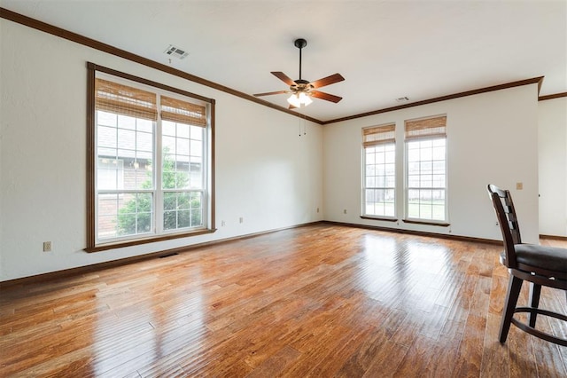 2613 NW 159th St, Edmond, OK 73013 - spare room with crown molding, plenty of natural light, ceiling fan, and wood finished floors