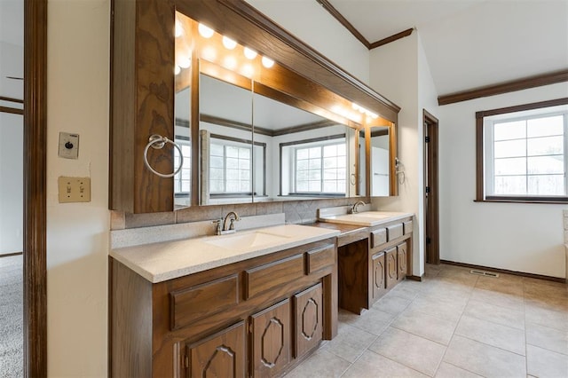 2613 NW 159th St, Edmond, OK 73013 - bathroom with crown molding, double vanity, baseboards, and tile patterned flooring