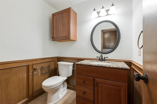2613 NW 159th St, Edmond, OK 73013 - half bathroom with vanity, wainscoting, toilet, and tile patterned flooring