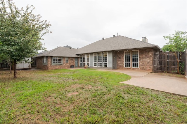2613 NW 159th St, Edmond, OK 73013 - back of property featuring brick siding, a patio area, and a chimney