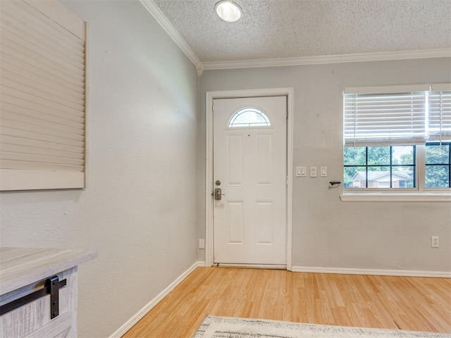 332 Crest Ln, Noble, OK 73068 - entrance foyer with light wood-style flooring, ornamental molding, and a textured ceiling