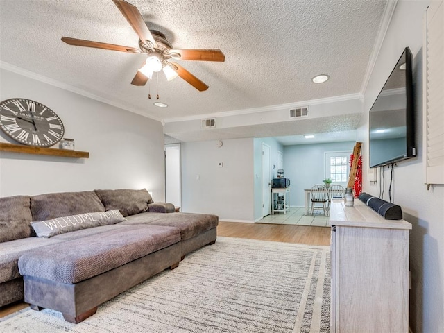 332 Crest Ln, Noble, OK 73068 - living room featuring a textured ceiling, crown molding, wood finished floors, a ceiling fan, and recessed lighting