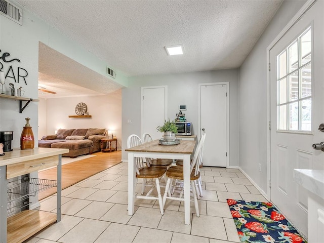 332 Crest Ln, Noble, OK 73068 - dining area with a textured ceiling and light tile patterned flooring