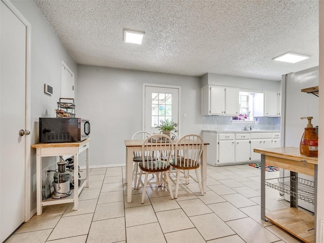 332 Crest Ln, Noble, OK 73068 - dining space featuring healthy amount of natural light, light tile patterned floors, and a textured ceiling