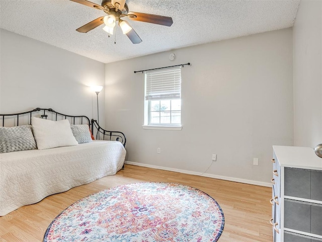 332 Crest Ln, Noble, OK 73068 - bedroom with wood finished floors, a textured ceiling, and ceiling fan