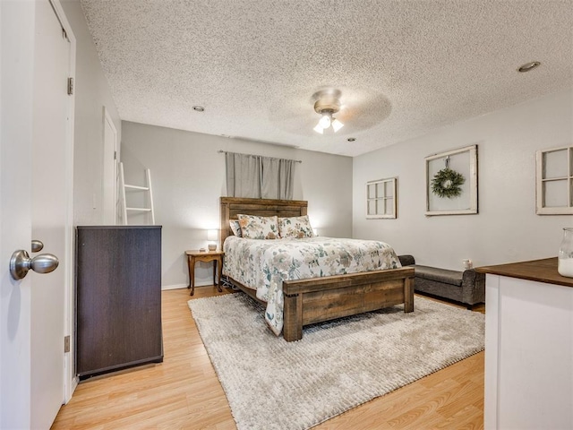 332 Crest Ln, Noble, OK 73068 - bedroom with light wood-type flooring, a textured ceiling, and a ceiling fan