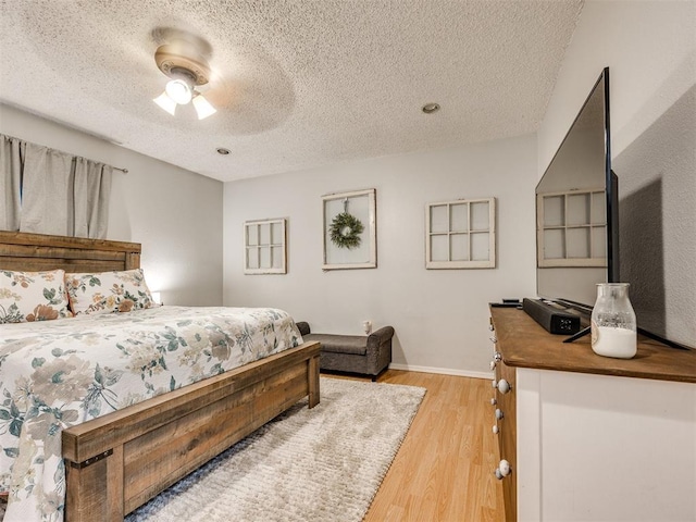 332 Crest Ln, Noble, OK 73068 - bedroom featuring a textured ceiling, wood finished floors, and a ceiling fan
