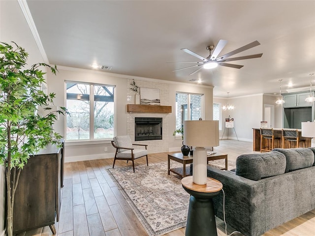 12825 Painted Sky, Edmond, OK 73007 - living room with a ceiling fan, healthy amount of natural light, crown molding, and light wood-type flooring