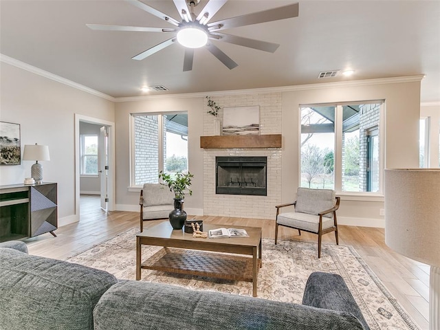 12825 Painted Sky, Edmond, OK 73007 - living area with crown molding, wood finished floors, ceiling fan, a brick fireplace, and baseboards