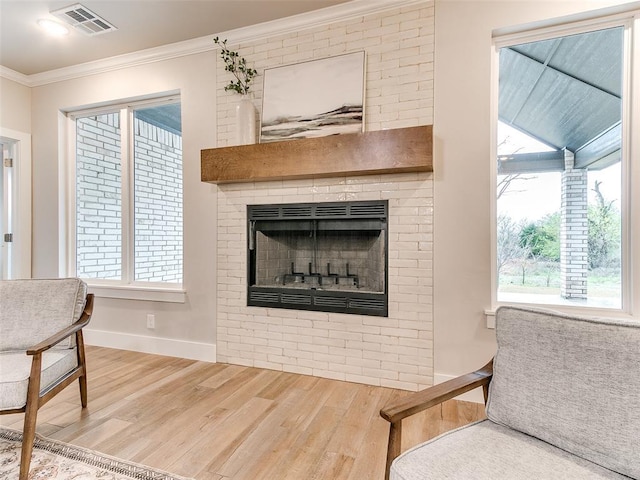 12825 Painted Sky, Edmond, OK 73007 - living room featuring ornamental molding, wood finished floors, a fireplace, and baseboards