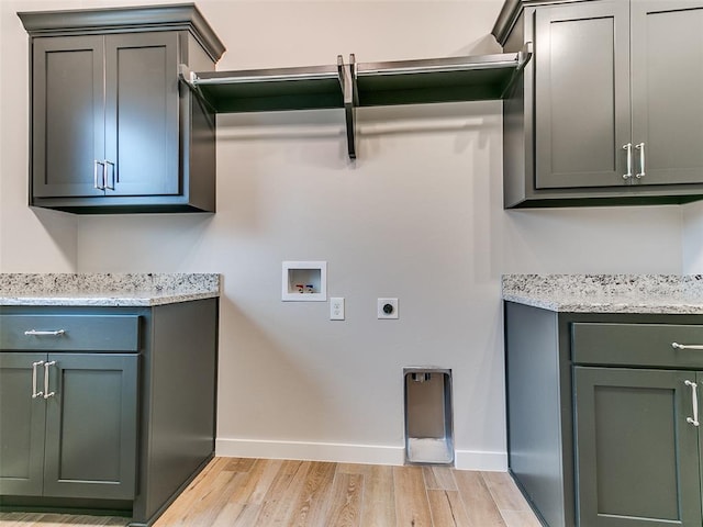 12825 Painted Sky, Edmond, OK 73007 - laundry area with hookup for a washing machine, cabinet space, light wood-style floors, electric dryer hookup, and baseboards