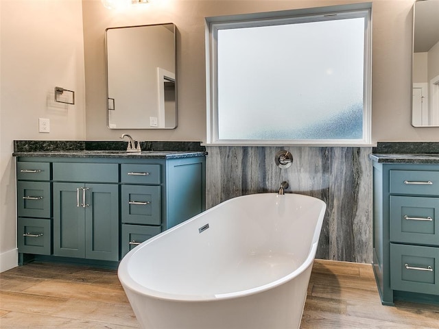 12825 Painted Sky, Edmond, OK 73007 - bathroom with wood finished floors, vanity, and a freestanding tub