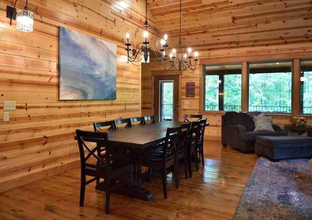 250 Almond Ln, Broken Bow, OK 74728 - dining room with vaulted ceiling, wood walls, wood-type flooring, a chandelier, and wooden ceiling