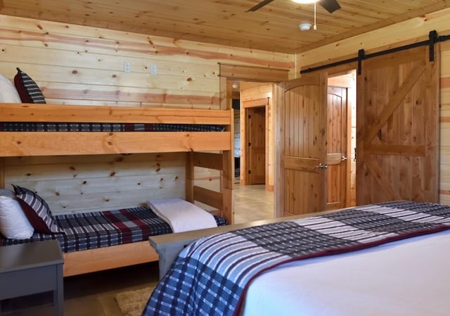250 Almond Ln, Broken Bow, OK 74728 - bedroom featuring wood ceiling, wood walls, and a barn door