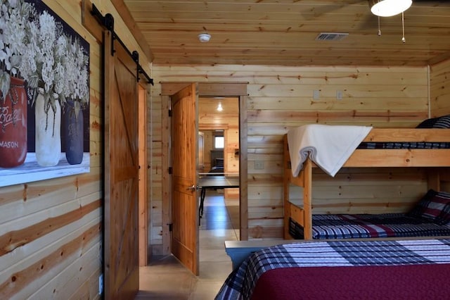 250 Almond Ln, Broken Bow, OK 74728 - bedroom featuring wood walls, wood ceiling, and a barn door