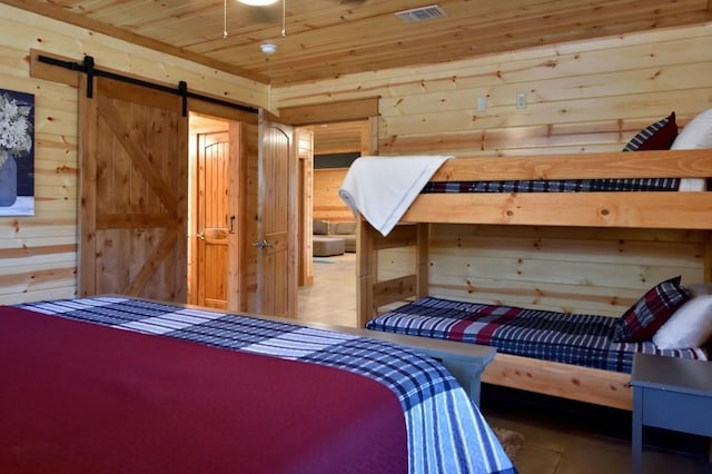 250 Almond Ln, Broken Bow, OK 74728 - tiled bedroom featuring wooden walls, a barn door, and wooden ceiling