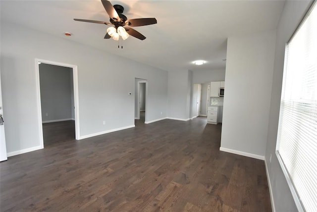 411 W Highland St, Shawnee, OK 74801 - unfurnished living room with ceiling fan, baseboards, and dark wood finished floors