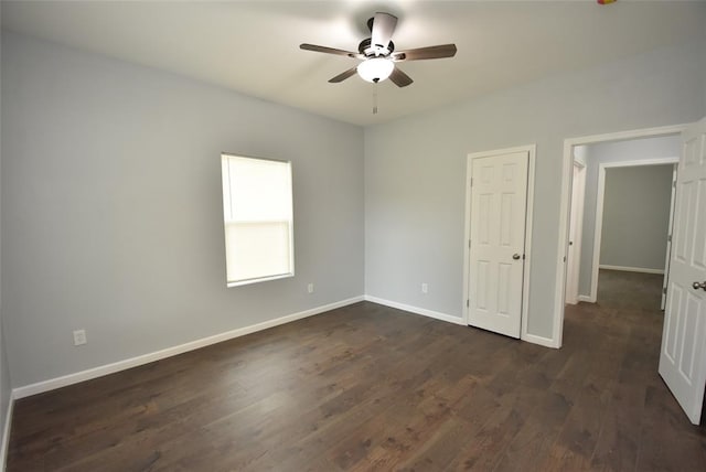 411 W Highland St, Shawnee, OK 74801 - unfurnished bedroom with baseboards, dark wood-type flooring, and ceiling fan