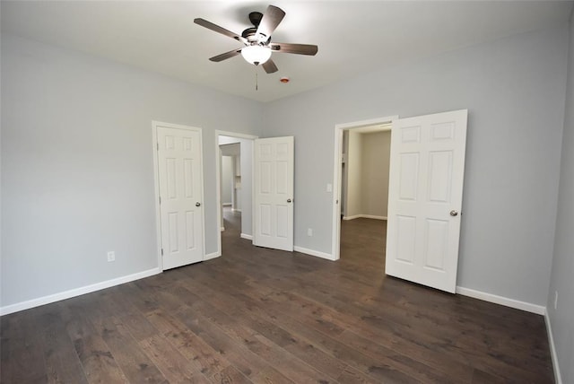 411 W Highland St, Shawnee, OK 74801 - unfurnished bedroom with dark wood-style floors, baseboards, and a ceiling fan