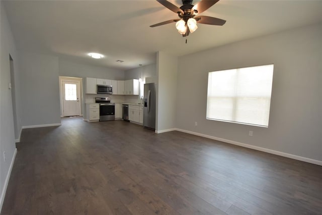 411 W Highland St, Shawnee, OK 74801 - unfurnished living room with ceiling fan and dark wood-style flooring