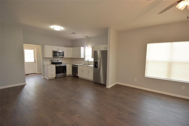411 W Highland St, Shawnee, OK 74801 - kitchen with stainless steel appliances, light countertops, white cabinets, and dark wood-style floors