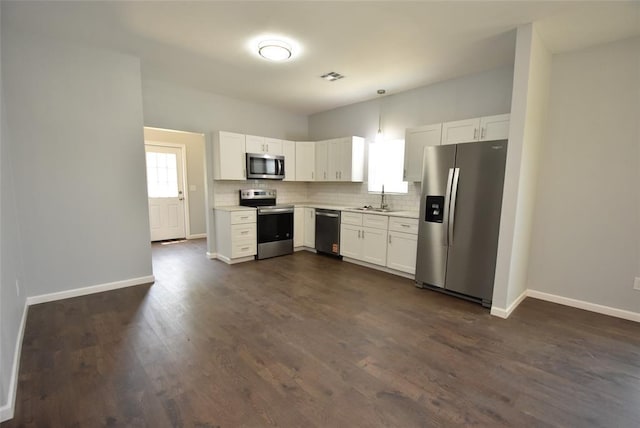 411 W Highland St, Shawnee, OK 74801 - kitchen featuring appliances with stainless steel finishes, light countertops, decorative backsplash, white cabinetry, and dark wood-style flooring
