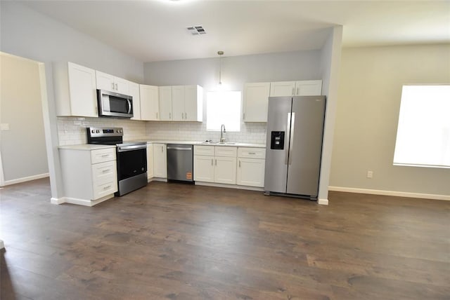 411 W Highland St, Shawnee, OK 74801 - kitchen featuring stainless steel appliances, tasteful backsplash, light countertops, and dark wood-type flooring