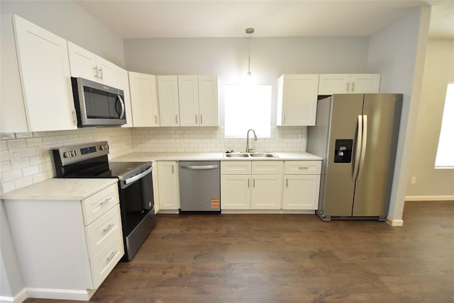 411 W Highland St, Shawnee, OK 74801 - kitchen with appliances with stainless steel finishes, white cabinets, backsplash, and light countertops