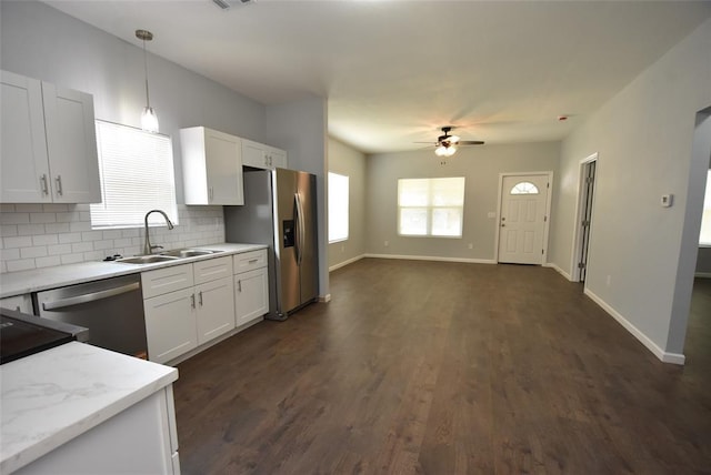 411 W Highland St, Shawnee, OK 74801 - kitchen featuring appliances with stainless steel finishes, a ceiling fan, backsplash, and white cabinetry