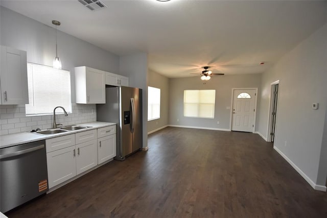 411 W Highland St, Shawnee, OK 74801 - kitchen with stainless steel appliances, ceiling fan, tasteful backsplash, white cabinetry, and dark wood-type flooring