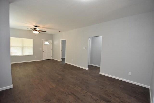 411 W Highland St, Shawnee, OK 74801 - unfurnished living room featuring a ceiling fan and dark wood-style flooring