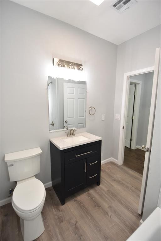411 W Highland St, Shawnee, OK 74801 - bathroom with vanity and wood finished floors