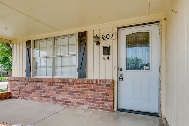 601 Woodland Way, Oklahoma City, OK 73127 - view of exterior entry featuring a porch and brick siding