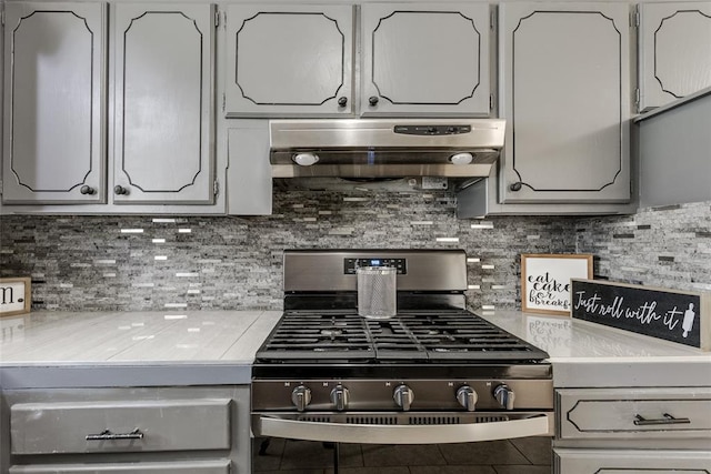 601 Woodland Way, Oklahoma City, OK 73127 - kitchen featuring gas stove, under cabinet range hood, light countertops, and decorative backsplash