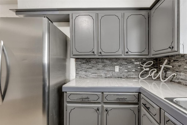 601 Woodland Way, Oklahoma City, OK 73127 - kitchen featuring freestanding refrigerator and gray cabinetry