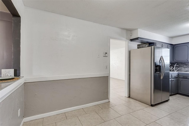 601 Woodland Way, Oklahoma City, OK 73127 - kitchen featuring stainless steel fridge with ice dispenser, a textured ceiling, light countertops, and light tile patterned flooring