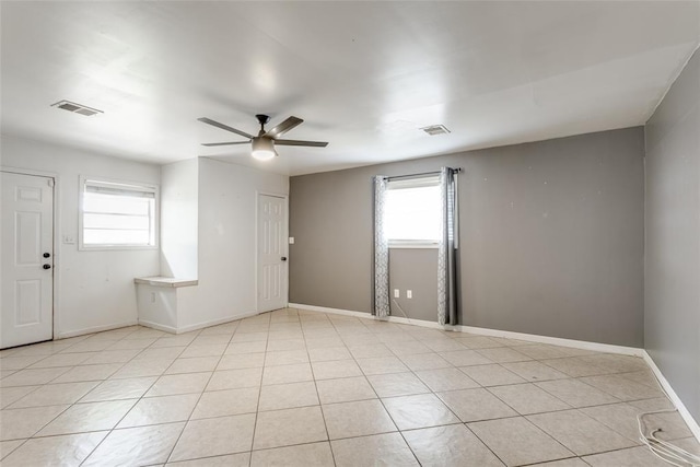 601 Woodland Way, Oklahoma City, OK 73127 - unfurnished room featuring a ceiling fan, healthy amount of natural light, and light tile patterned flooring