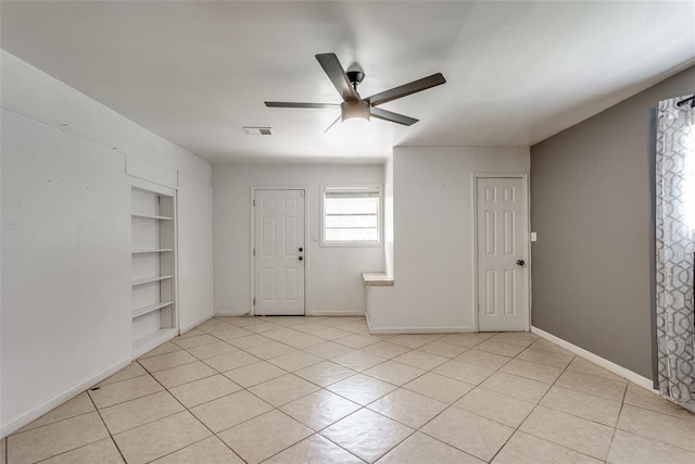 601 Woodland Way, Oklahoma City, OK 73127 - empty room featuring built in features, a ceiling fan, and light tile patterned floors