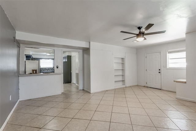 601 Woodland Way, Oklahoma City, OK 73127 - unfurnished room featuring a ceiling fan, built in features, and light tile patterned floors