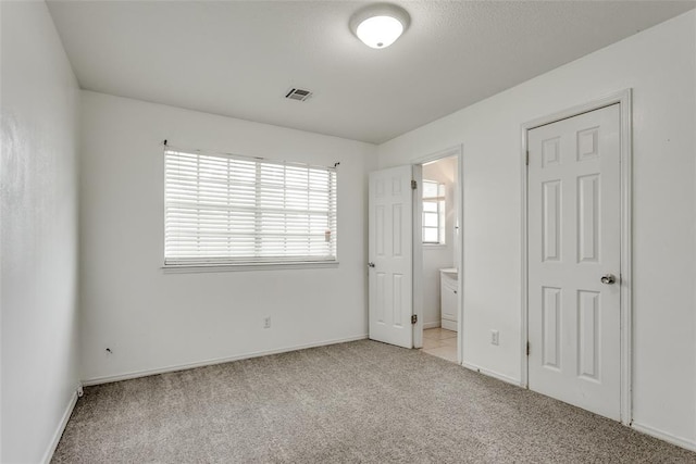 601 Woodland Way, Oklahoma City, OK 73127 - unfurnished bedroom featuring light carpet and ensuite bathroom